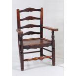 A George III elm and fruitwood childs ladderback elbow chair, having panelled seat and turned