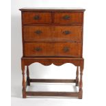 An early 18th century walnut and inlaid chest-on-stand, having a four-quarter veneered top over