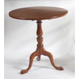 A George III mahogany pedestal tripod table, having a circular tilt-top to a baluster turned