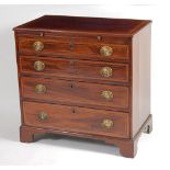 A late Georgian mahogany and satinwood crossbanded chest, having a brushing slide over four long