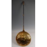 A 17th century Dutch brass warming pan, the circular hinged cover repousee decorated with a