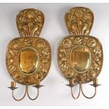 A pair of Dutch brass twin light wall sconces, in the 17th century style, each embossed with fruit