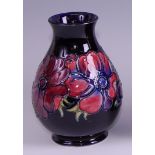 A contemporary Moorcroft pottery vase in the Anemone pattern, of baluster form, underglaze painted