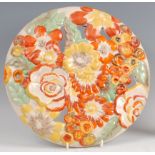 A 1930s Clarice Cliff pottery circular wall charger, pierced and floral stylised moulded,