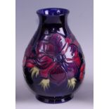 A contemporary Moorcroft pottery vase in the Anemone pattern, of baluster form, underglaze painted