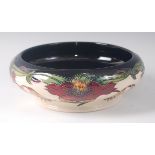 A modern Moorcroft pottery bowl in the Anna Lily pattern, designed by Nicola Slaney, of squat