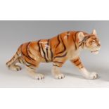 Royal Dux - a large porcelain model of a Tiger, in prowling pose, underglaze painted, with raised