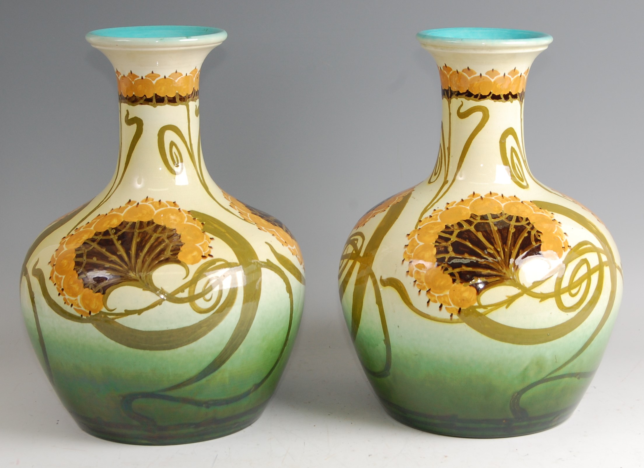 A pair of large Art Nouveau pottery vases, in the style of William Morris, each underglaze floral