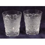A pair of contemporary Lalique frosted and moulded glass tumblers, each of circular tapering form,