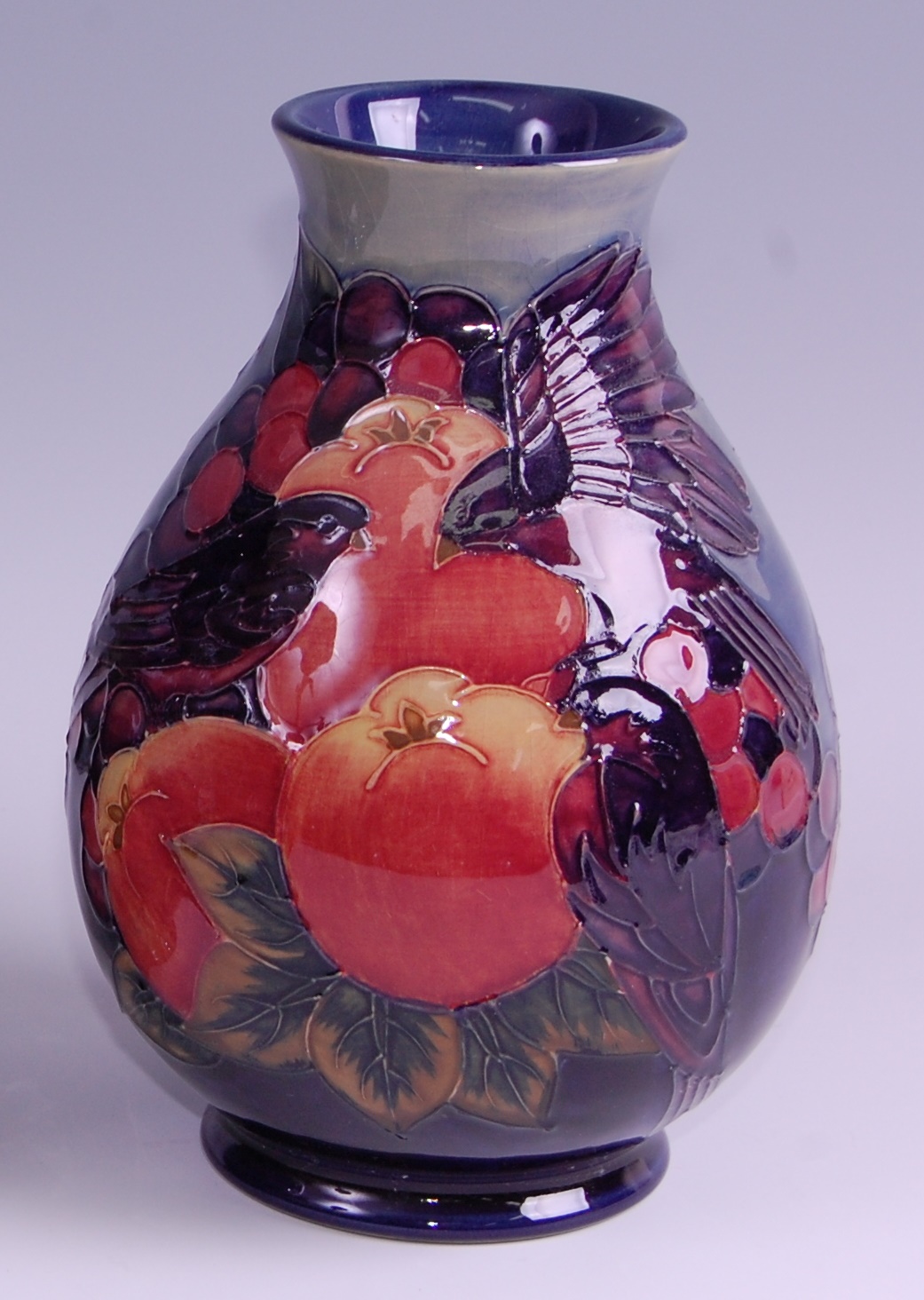 A modern Moorcroft pottery vase in the Finches & Fruit pattern, of baluster form, underglaze painted