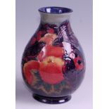 A modern Moorcroft pottery vase in the Finches & Fruit pattern, of baluster form, underglaze painted