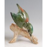 Royal Dux - a porcelain model of a Green Kingfisher, perched on a branch, underglaze painted, with