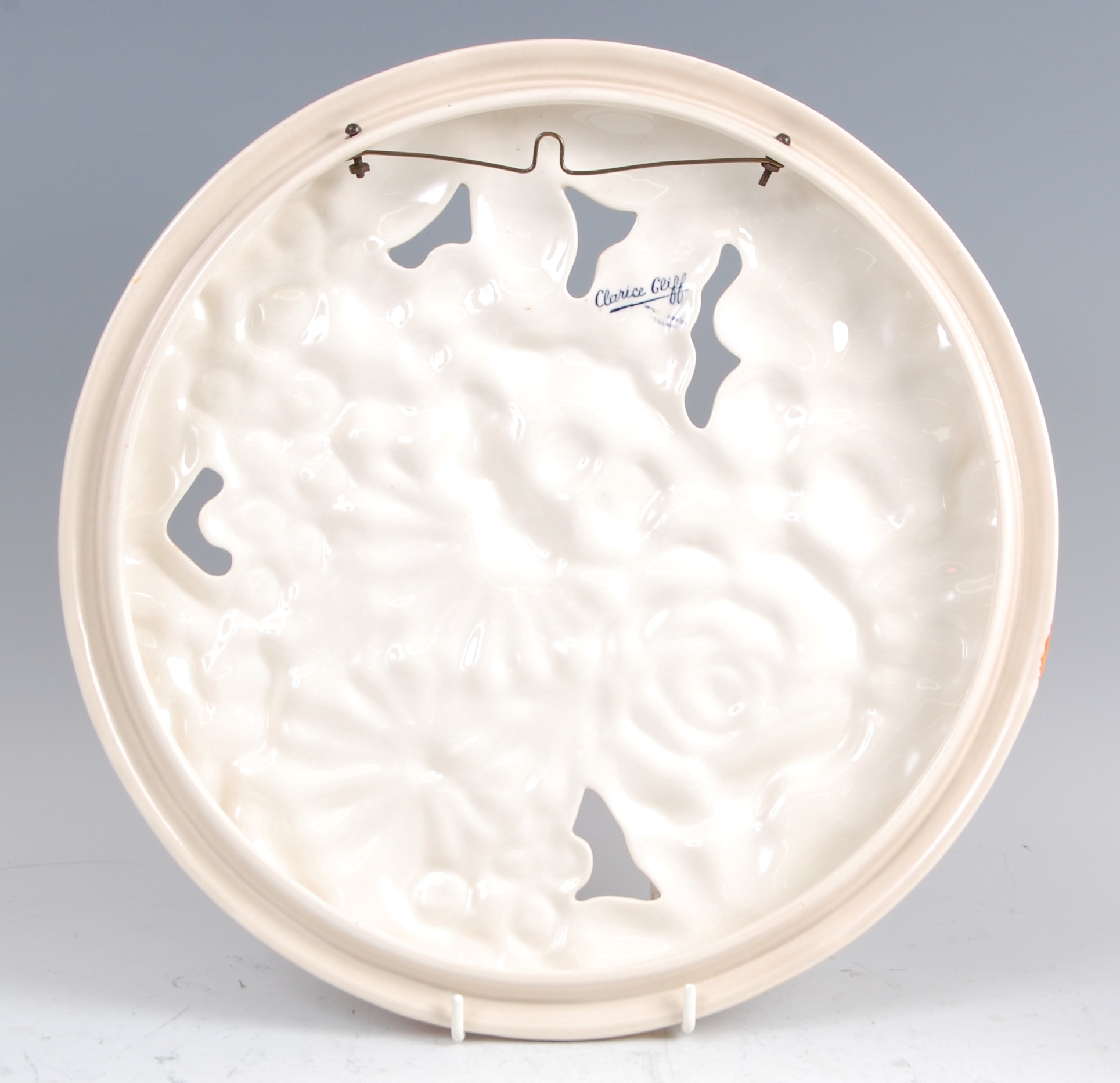 A 1930s Clarice Cliff pottery circular wall charger, pierced and floral stylised moulded, - Image 2 of 3