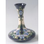 A modern Moorcroft pottery vase in the Florence pattern, designed by Rachel Bishop, the waisted neck