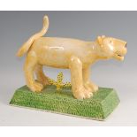 Paddy Peters - a large contemporary pottery model of a smiling Lion, in standing pose, raised on