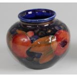 A Moorcroft pottery miniature shouldered squat vase in the Pomegranate pattern, underglaze painted