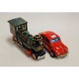A Chinese battery operated model of a Volkswagen Beetle together with a tinplate Western locomotive