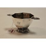 A Victorian silver porringer, of fluted octagonal form, having pierced twin handles and gilt-