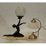 An Art Deco style table lamp the spelter female figure in dancing pose with one arm raised holding a