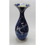 A large blue & white stoneware vase having a flared rim to a slender neck and bulbous lower body