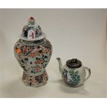 A 19th century porcelain teapot of bullet shape, transfer decorated in the Chinese style having a