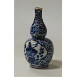 A Chinese blue and white double-gourd vase, the central panel decorated with a bird amongst