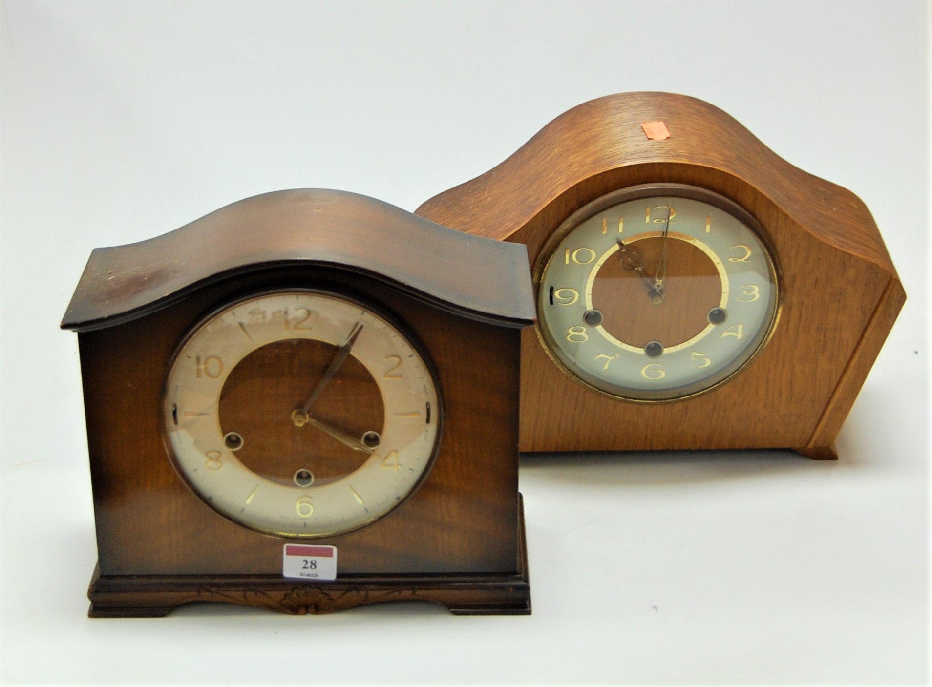A 1950s oak cased mantel clock having a silvered dial with Arabic numerals and chiming movement,