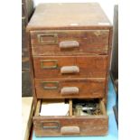 A pine four drawer chest containing a large quantity of pocket watch parts, dials, assorted