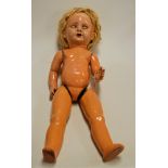 A mid-20th century continental composition doll, having rolling blue eyes and open mouth showing