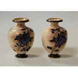 A pair of Victorian Doulton Burslem porcelain vases, of squat baluster form, on mottled cream