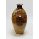 A large 20th century studio pottery vase of ovoid form on a brown ground, height 46cm