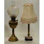 An early 20th century brass pedestal oil lamp having etched globular shade, together with a brass