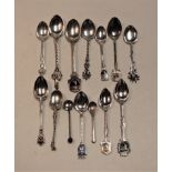 A small collection of assorted silver and white metal English and continental souvenir spoons