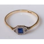 An Art Deco 18ct gold blue sapphire dress ring, the small baguette cut sapphire flanked to either