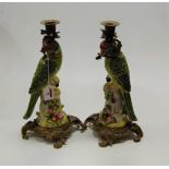 A pair of reproduction figural table candle sticks each in the form of a parrot having gilt metal