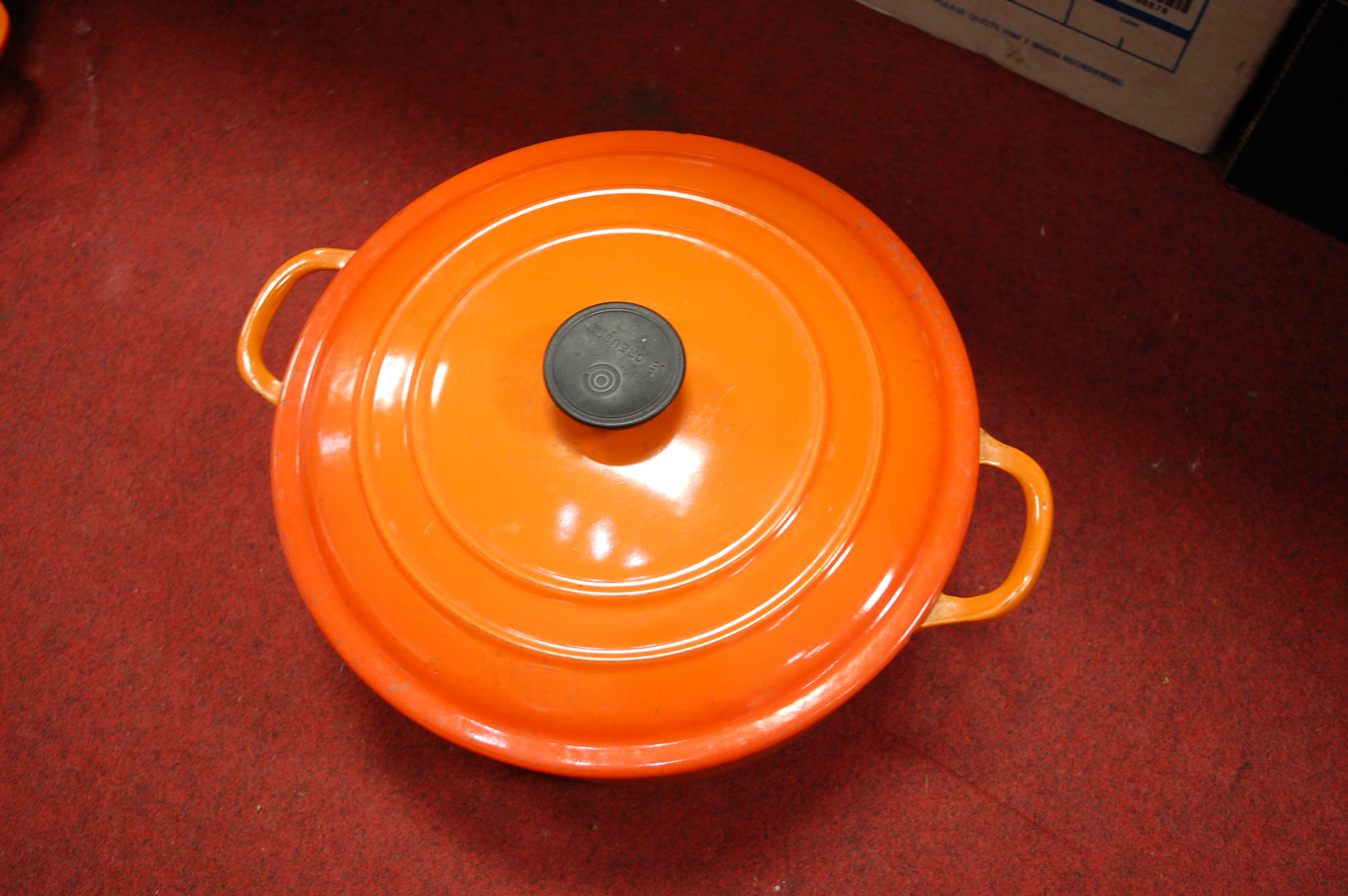 A Le Creuset orange enamelled casserole dish and cover together with one other smaller example (2) - Image 7 of 12