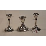 A pair of 20th century silver dwarf table candlesticks, each on loaded base; together with one other