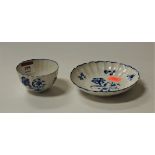 An 18th century Worcester porcelain tea bowl and saucer, the bowl decorated with flowers, with