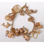 A modern 9ct gold charm bracelet, set with various principally 9ct gold charms, gross weight 35g