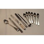 A small collection of assorted loose silver and white metal flatware, to include teaspoons, silver