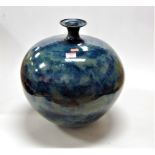 A large studio pottery vase of globular form on a mottled blue ground, height approx 40cm