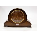 A 1950s oak cased mantel clock having raised Roman numerals and chiming movement