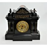A Victorian black slate mantel clock, of architectural form, the brass dial showing Arabic