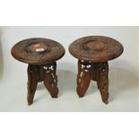 A pair of Indonesian heavily carved plant stands