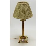 A lacquered brass Corinthian column table lamp on onyx base and further lacquered brass paw feet