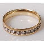 A 9ct gold diamond half eternity ring, arranged as eleven channel set small brilliants, total