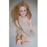 An Armand Marseille bisque head doll, having rolling brown eyes and open mouth, with jointed