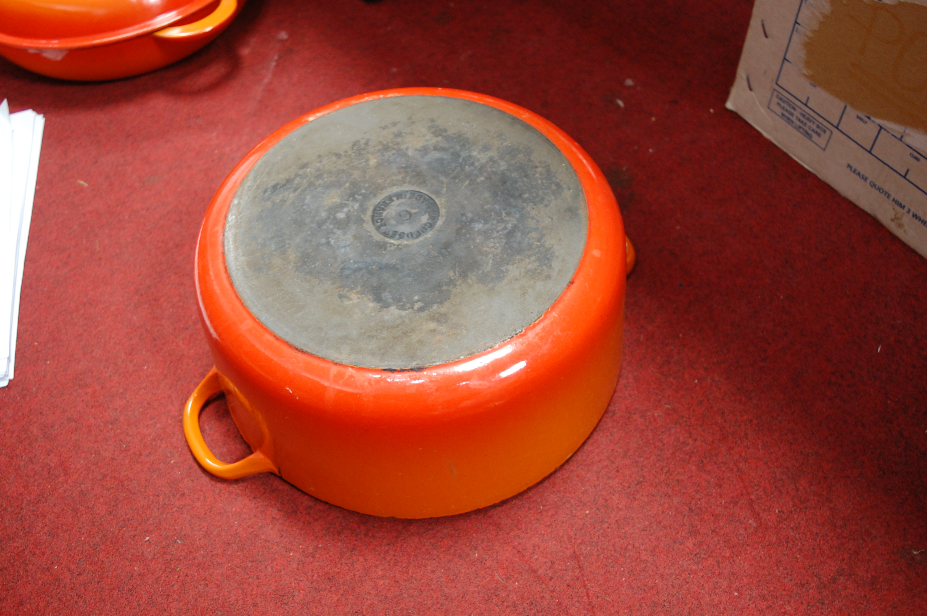 A Le Creuset orange enamelled casserole dish and cover together with one other smaller example (2) - Image 11 of 12