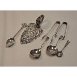 A George III silver caddy spoon, having bright cut decorated bowl and plain stem; together with