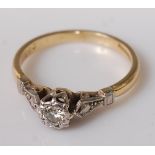 An 18ct gold and platinum diamond solitaire ring, the illusion set round cut diamond weighing approx